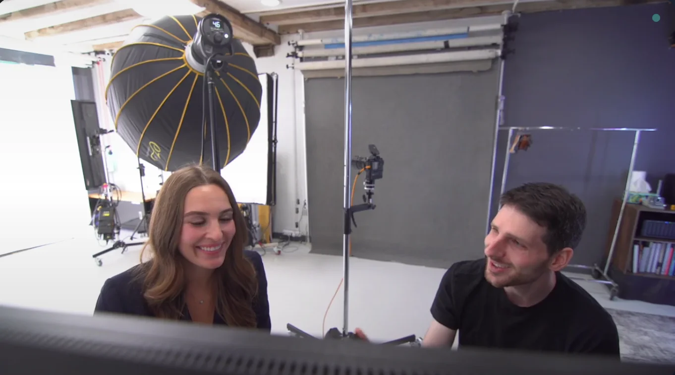 Photographer and client reviewing headshot photos together on computer screen during selection process